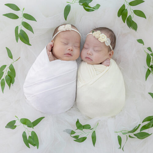 A close-up photograph of a peacefully sleeping newborn babies