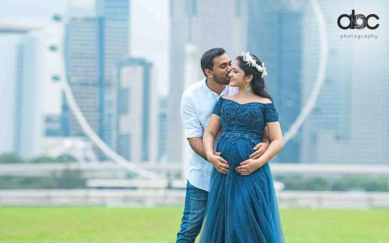 An Indian couple enjoying an outdoor maternity photoshoot captured by abc photography