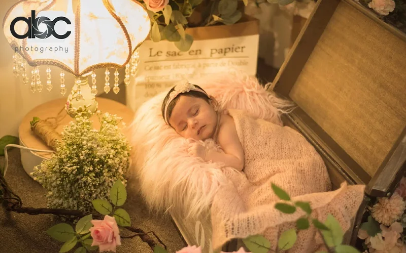 A photoshoot of a baby sleeping