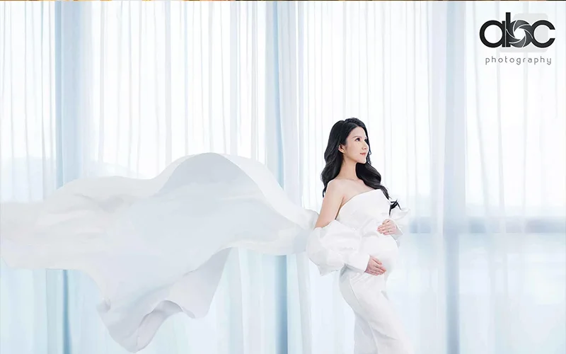 Asian woman posing for pregnancy photoshoot