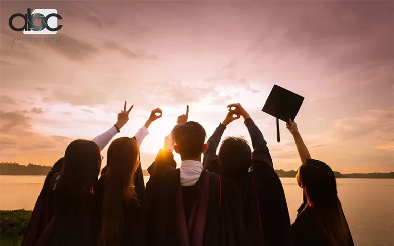 Students gazing at the sky in their graduation gowns