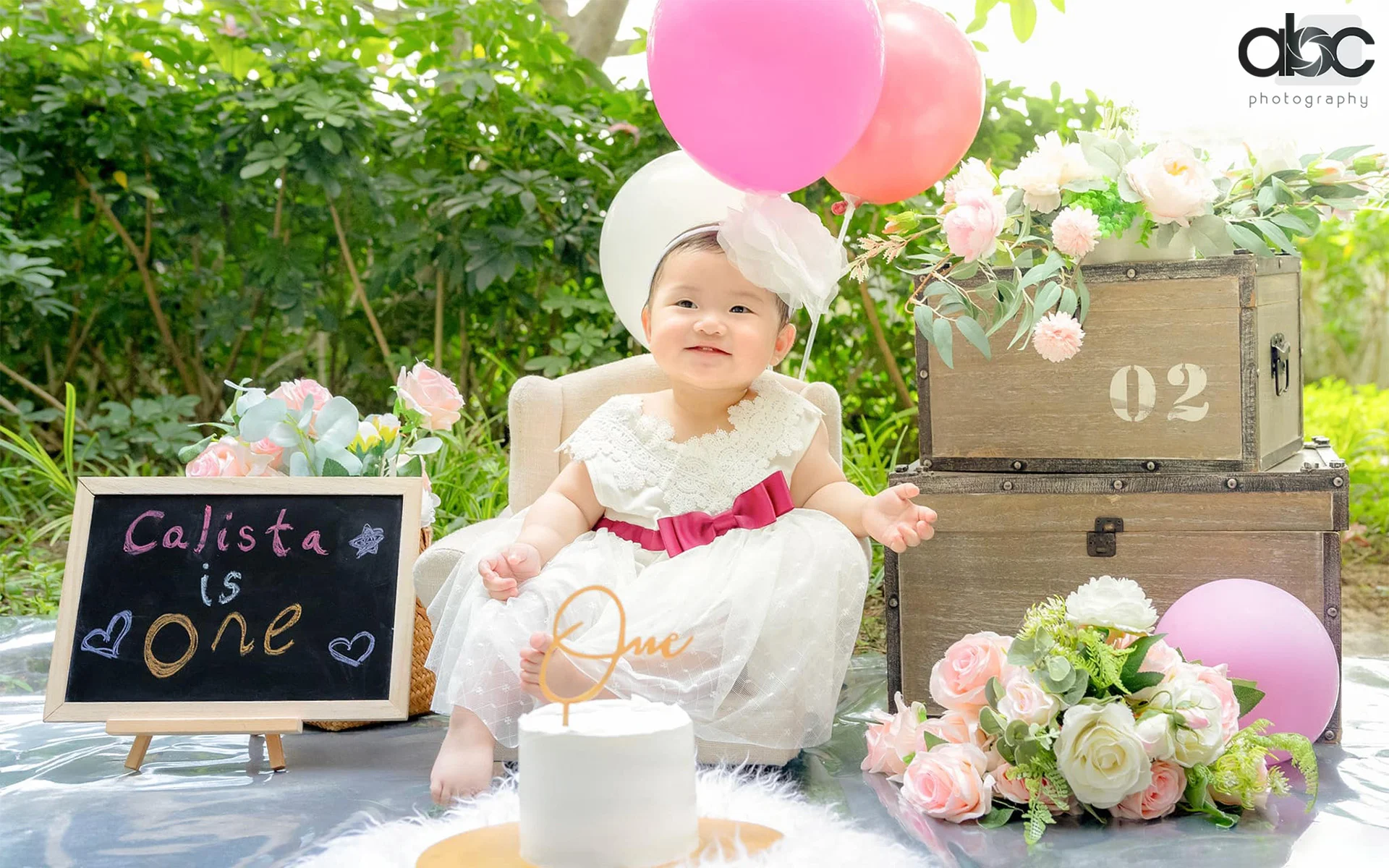 Baby's first birthday outdoor celebration setup with balloons