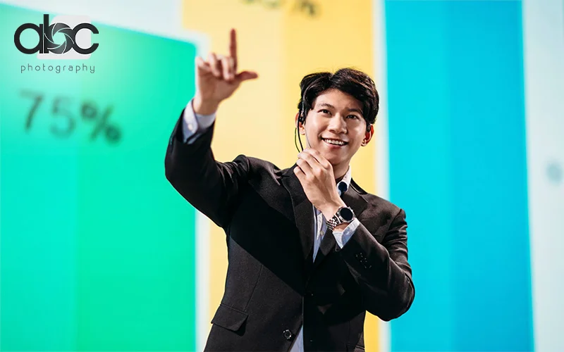 Male employee giving speech for business event