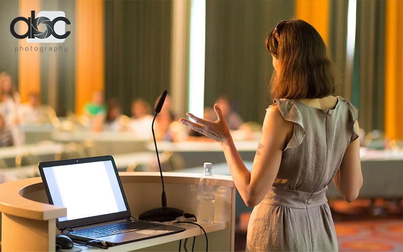 Professionals giving speech for business event