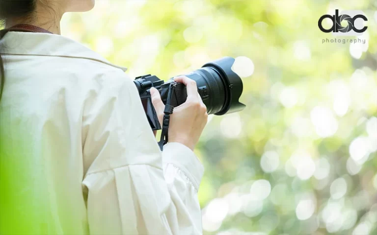 woman holding a camera for outdoor photoshoot