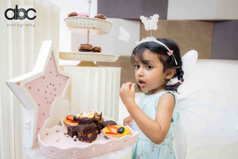 Girl eating cupcake at birthday party