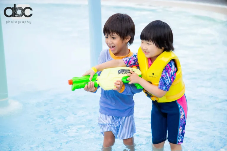 Kids playing with water guns at party