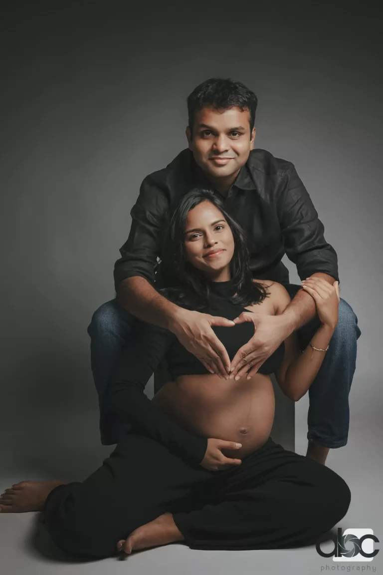 Couple maternity portrait in dark studio