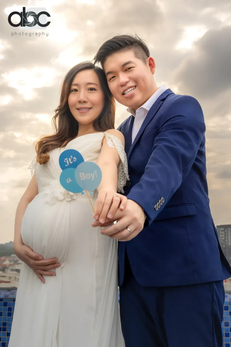Couple holding baby shoes pregnancy photoshoot