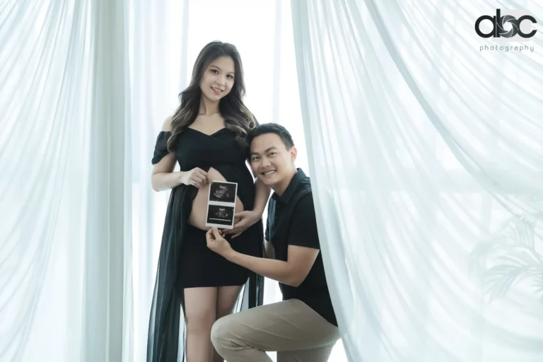Couple pregnancy photoshoot with baby crib prop
