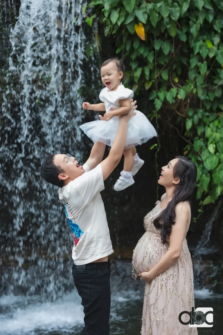 Outdoor family maternity photoshoot by waterfall