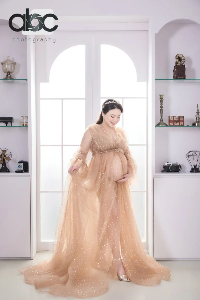 Maternity photoshoot studio with peach gown
