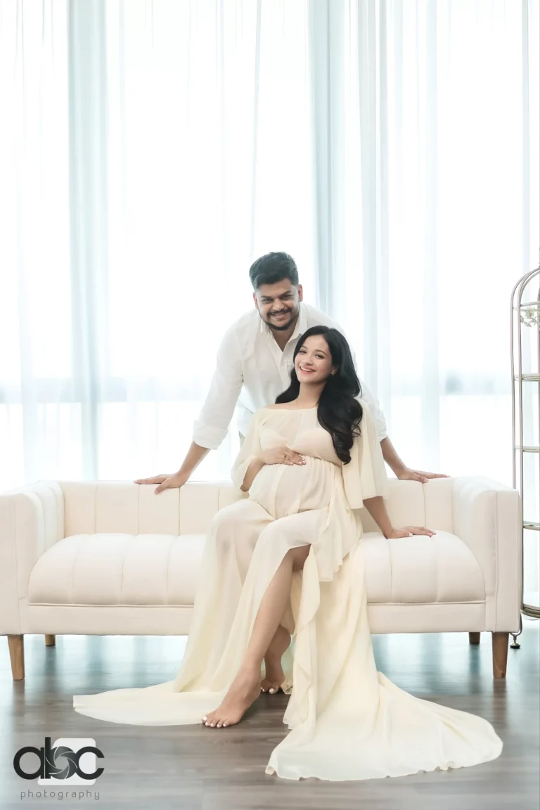 Couple maternity photoshoot Singapore cream sofa