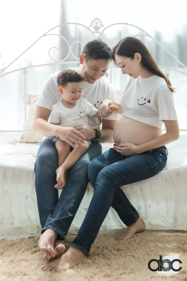 Family maternity photoshoot sitting on floor
