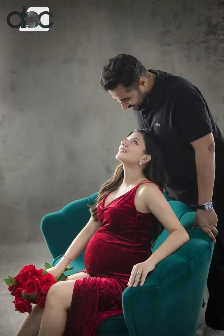 Couple maternity photoshoot on green armchair