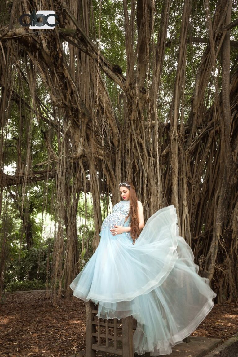 Pregnant woman in tulle under banyan tree