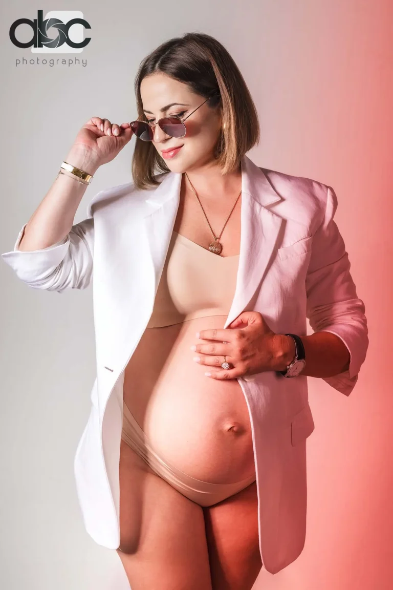 Pregnant woman in blazer and sunglasses