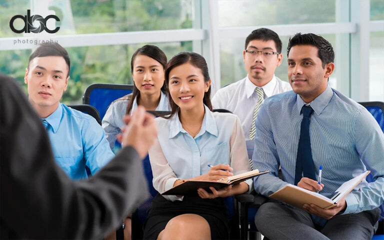 Group listening to business presentation indoors.