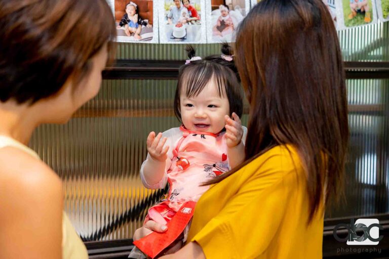 Baby girl with mother at party photography