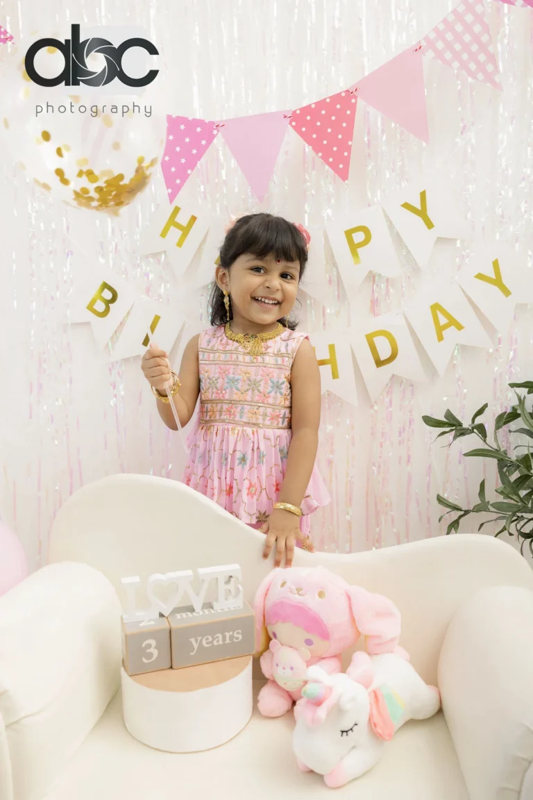 Girl at Happy Birthday photoshoot backdrop