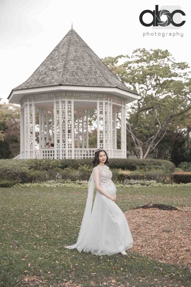 Outdoor maternity photoshoot at garden gazebo