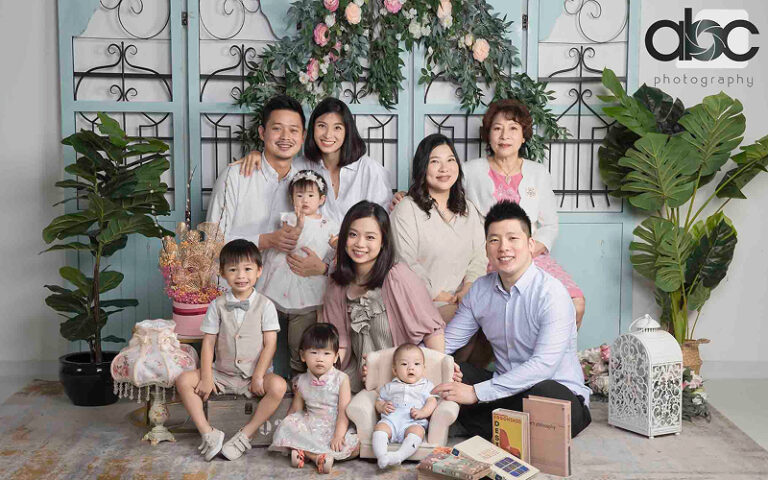 Multigenerational family posing for a portrait at ABC Photography.