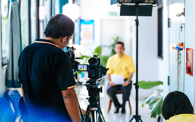 Video recording setup with camera and subject.