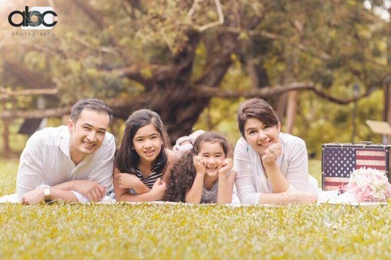 Family lying on grass outdoor photoshoot