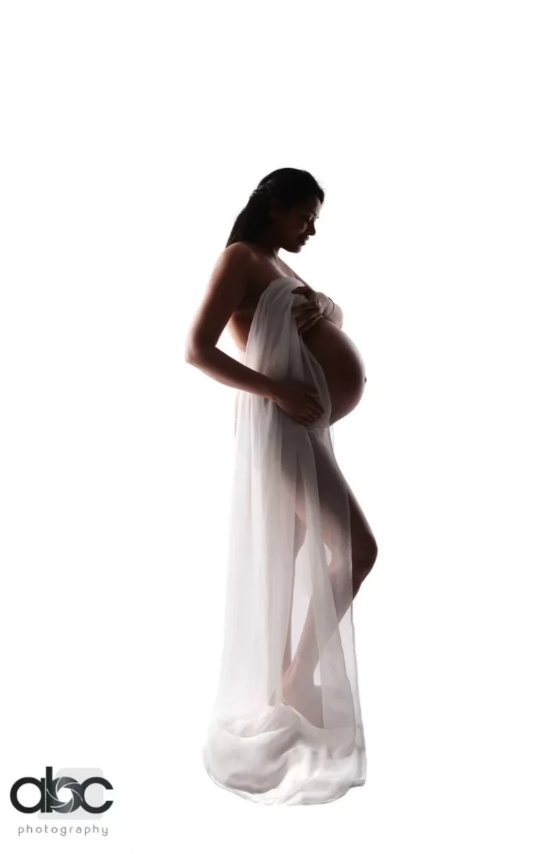 Maternity silhouette in sheer white gown