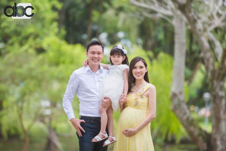 Family pregnancy photoshoot with daughter outdoors