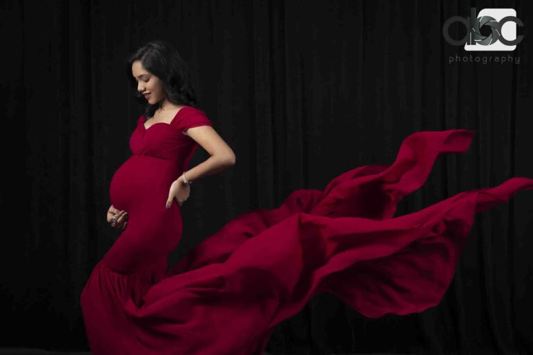 Maternity portrait in flowing red gown