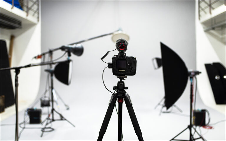 Camera on tripod setups portrait photography composition in studio.
