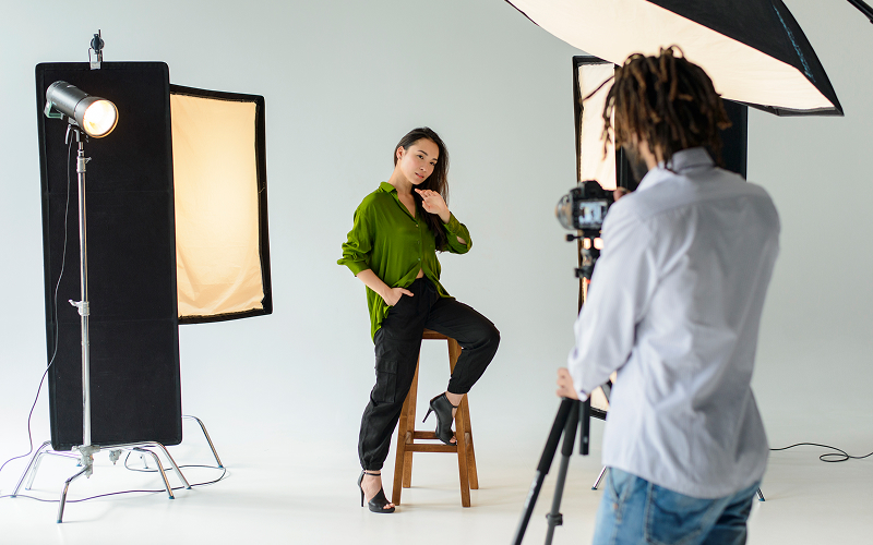 Photographer captures portrait photography composition of a seated model.